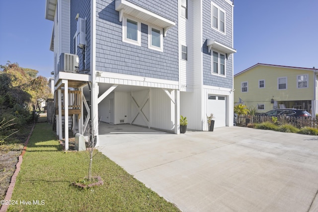 304 Birmingham Ave Unit 2, Carolina Beach, NC 28428 - view of front of house with stairway, a garage, concrete driveway, cooling unit, and a carport