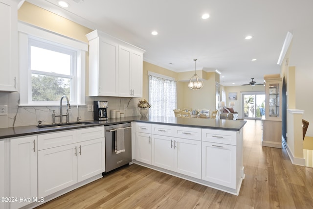 304 Birmingham Ave Unit 2, Carolina Beach, NC 28428 - kitchen with stainless steel dishwasher, a sink, dark countertops, recessed lighting, and ornamental molding