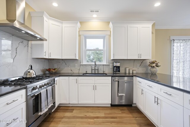 kitchen with kitchen peninsula, white cabinets, sink, pendant lighting, and dishwasher