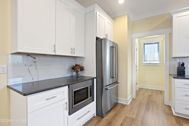304 Birmingham Ave Unit 2, Carolina Beach, NC 28428 - kitchen featuring appliances with stainless steel finishes, dark countertops, tasteful backsplash, light wood-style floors, and white cabinets