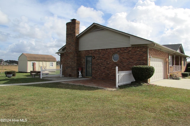 view of property exterior featuring a garage, a lawn, and a storage shed