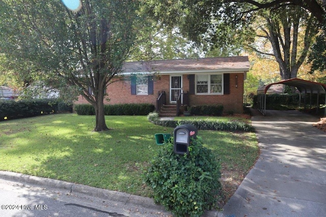 view of front of home with a front lawn and a carport