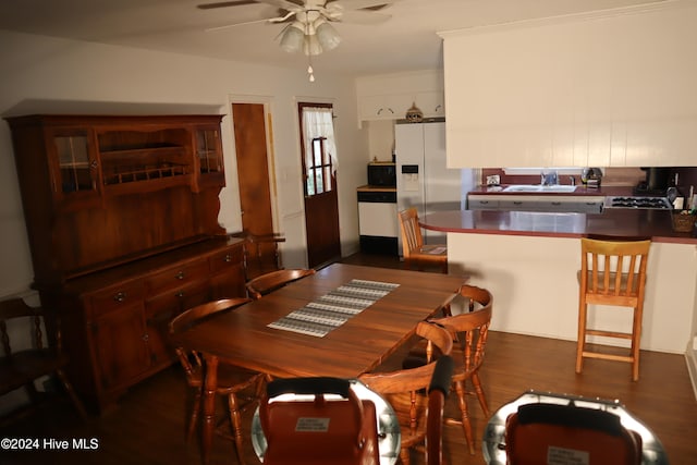 dining space featuring ceiling fan, dark hardwood / wood-style flooring, and sink