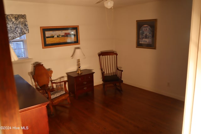 living area featuring hardwood / wood-style floors and ceiling fan