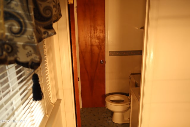 bathroom with tile patterned floors, vanity, and toilet