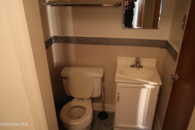 bathroom featuring tile patterned flooring, vanity, and toilet