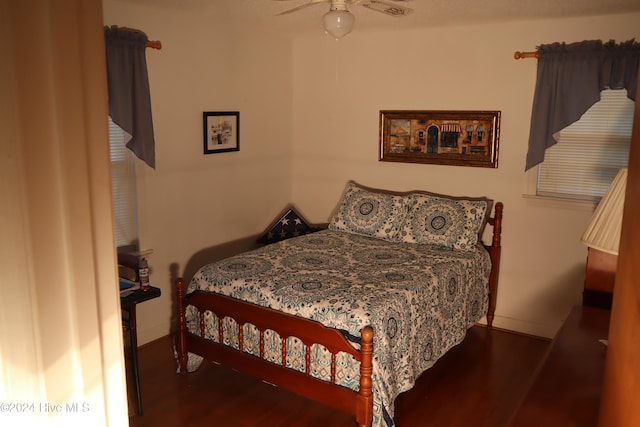 bedroom with ceiling fan and dark hardwood / wood-style floors