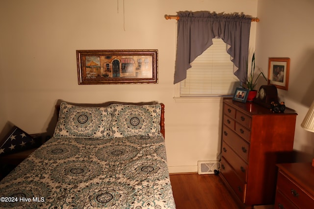 bedroom with dark wood-type flooring