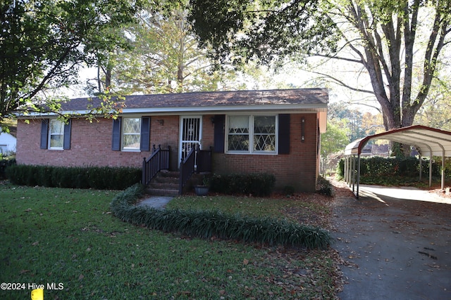 view of front facade with a front yard and a carport