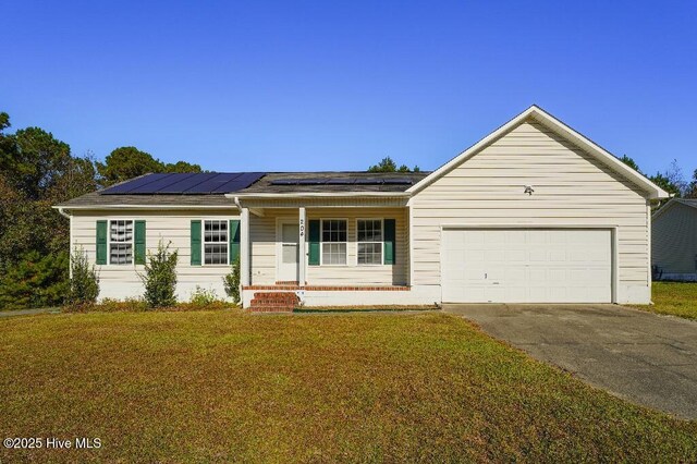 ranch-style home with a front lawn, a garage, solar panels, and a porch