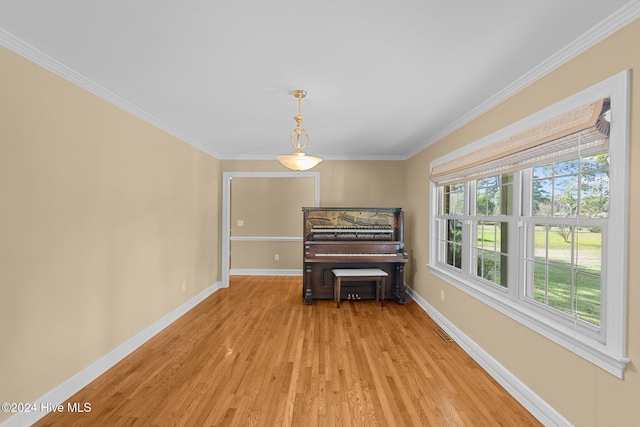 interior space featuring light hardwood / wood-style flooring and crown molding