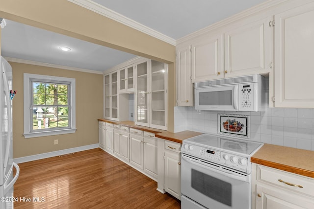 kitchen with light hardwood / wood-style floors, white cabinets, decorative backsplash, ornamental molding, and white appliances