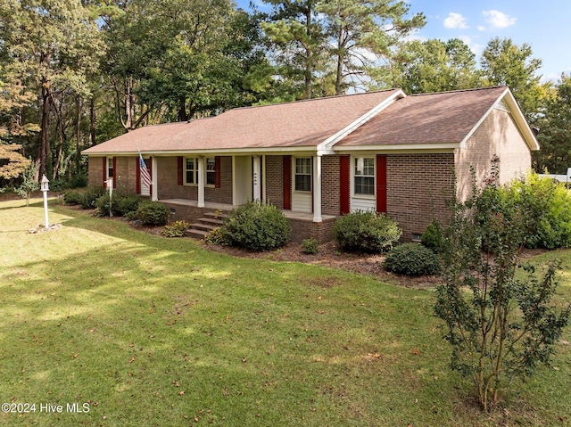 ranch-style house featuring a front yard and covered porch