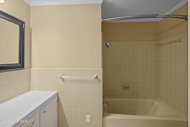 bathroom with tile walls, tiled shower / bath, and crown molding