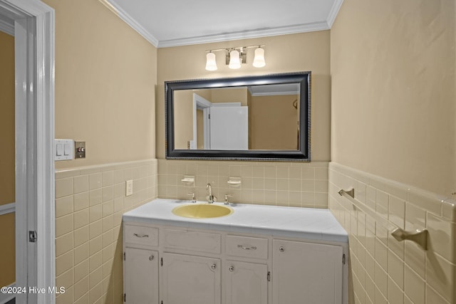 bathroom featuring vanity, tile walls, and ornamental molding