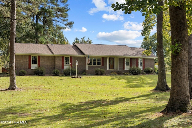 ranch-style home featuring a front yard