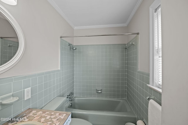 full bathroom featuring toilet, tile walls, tiled shower / bath, and crown molding