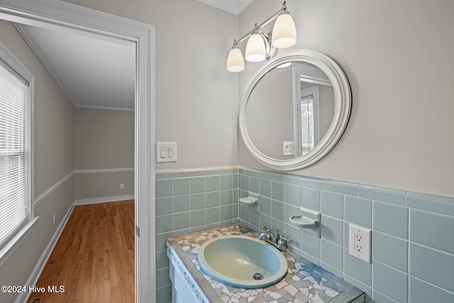 bathroom with ornamental molding, hardwood / wood-style floors, and vanity