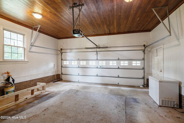 garage featuring a garage door opener, fridge, and wood ceiling