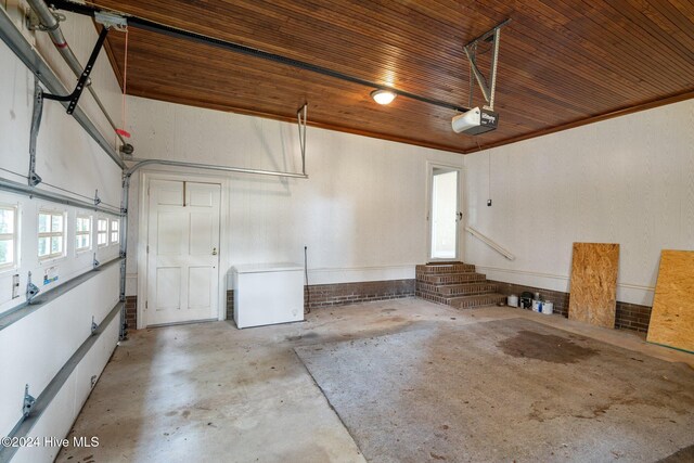 garage with wooden ceiling, a garage door opener, and fridge