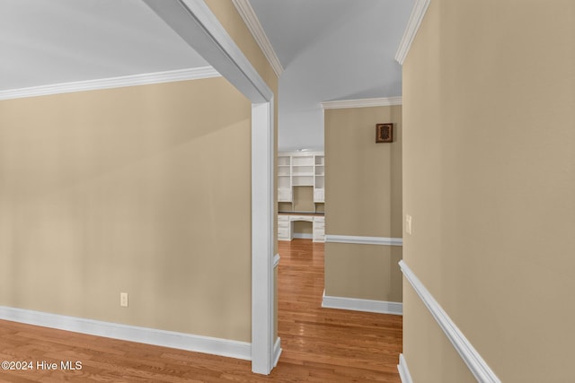 hall with hardwood / wood-style floors and ornamental molding