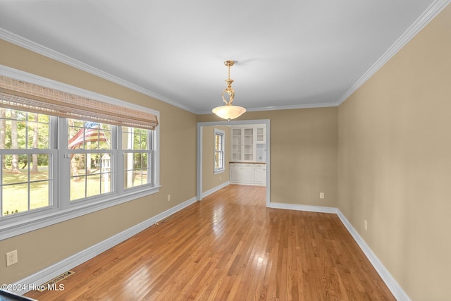 unfurnished room featuring ornamental molding and light hardwood / wood-style floors