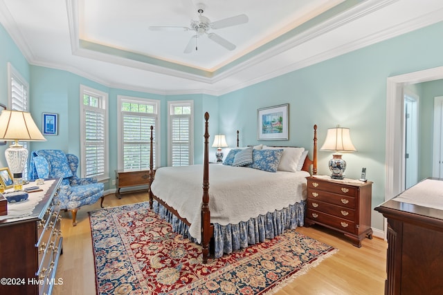 bedroom with multiple windows, ceiling fan, and light wood-type flooring