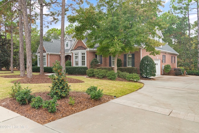 view of front facade with a front lawn and a garage