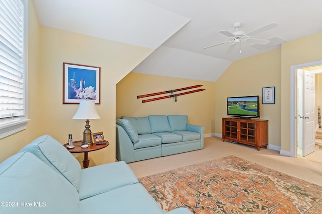 carpeted living room featuring ceiling fan and vaulted ceiling