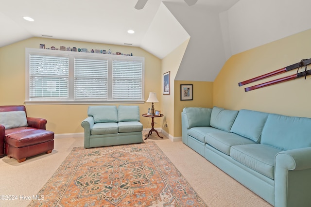 living room with carpet flooring, a healthy amount of sunlight, and vaulted ceiling