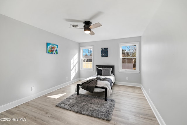 sitting room with a wealth of natural light, light wood-type flooring, and ceiling fan