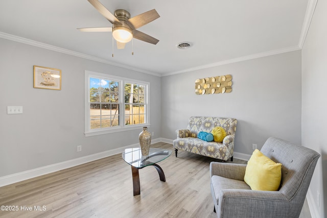 living area featuring ceiling fan, light hardwood / wood-style flooring, and ornamental molding