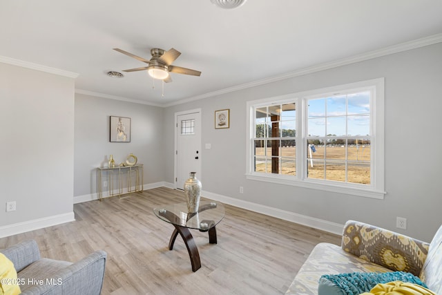 sitting room featuring light hardwood / wood-style floors, ceiling fan, and ornamental molding