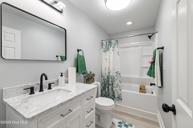 full bathroom featuring shower / tub combo, vanity, toilet, and wood-type flooring