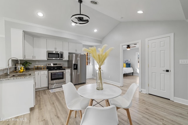 kitchen featuring appliances with stainless steel finishes, ceiling fan, sink, light hardwood / wood-style flooring, and white cabinets