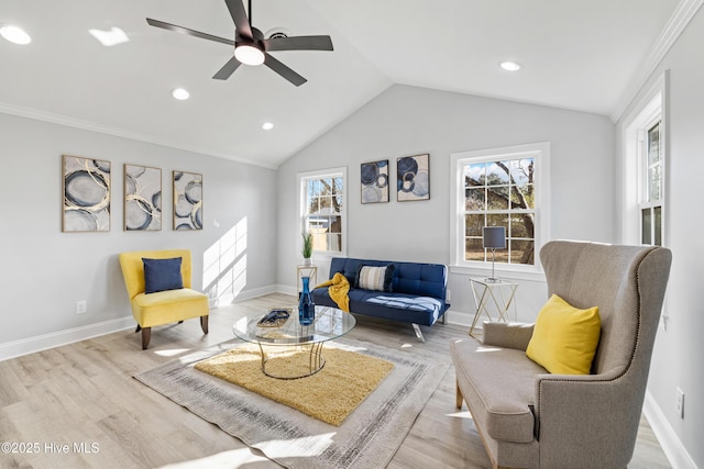 living room with a wealth of natural light, ceiling fan, lofted ceiling, and light wood-type flooring