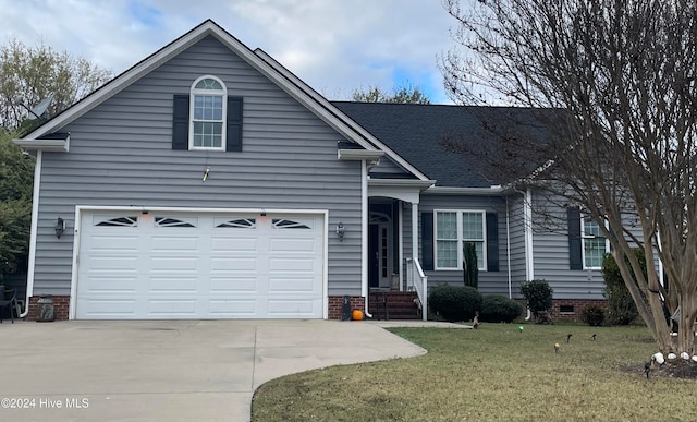 view of front of house with a front yard and a garage