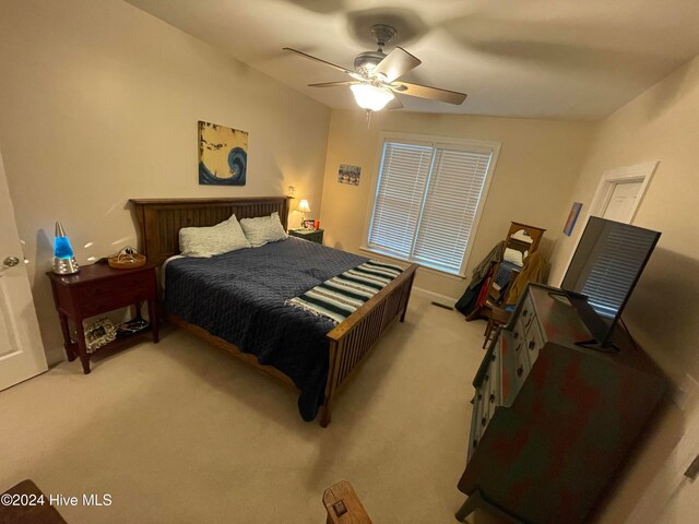 bedroom with light carpet and ceiling fan