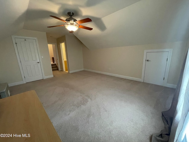 bonus room with light colored carpet, vaulted ceiling, and ceiling fan