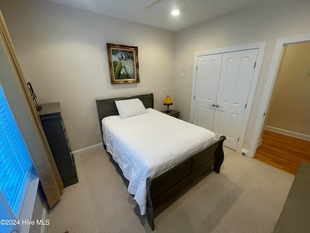 bedroom featuring a closet, ceiling fan, and light hardwood / wood-style flooring