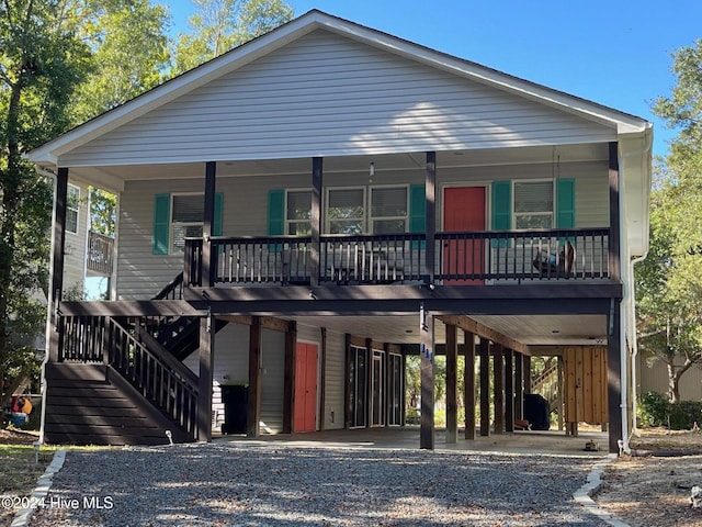 view of front of property with covered porch and a carport