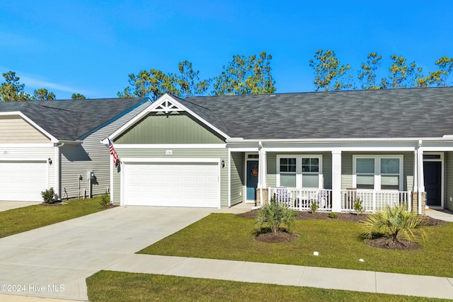 ranch-style home featuring a porch, a garage, and a front yard