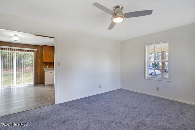 empty room featuring hardwood / wood-style flooring, a healthy amount of sunlight, and ceiling fan