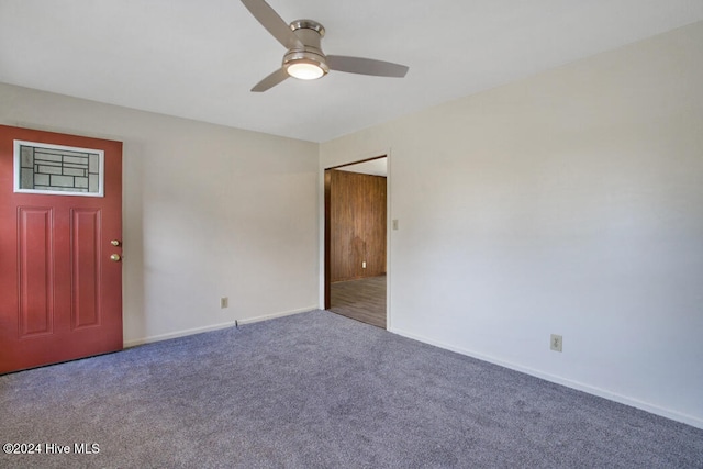 carpeted spare room with ceiling fan