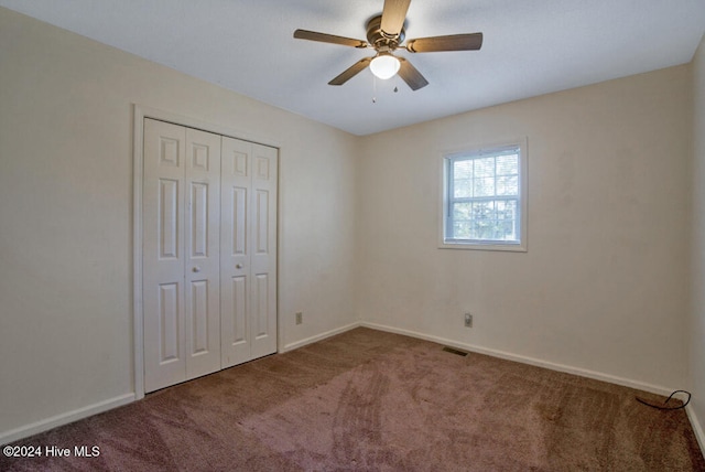 unfurnished bedroom featuring ceiling fan, carpet flooring, and a closet