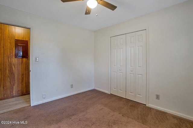 unfurnished bedroom with carpet floors, ceiling fan, and a closet