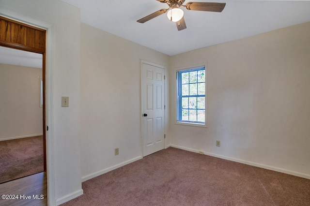 unfurnished bedroom featuring light colored carpet and ceiling fan