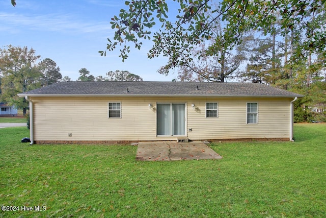 back of property featuring a patio and a yard