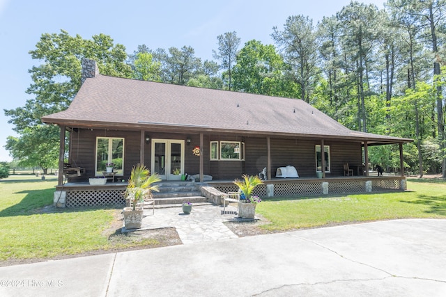 view of front facade with french doors and a front lawn