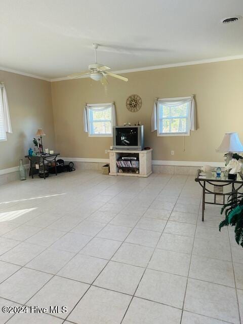 tiled living room featuring ornamental molding, a wealth of natural light, and ceiling fan